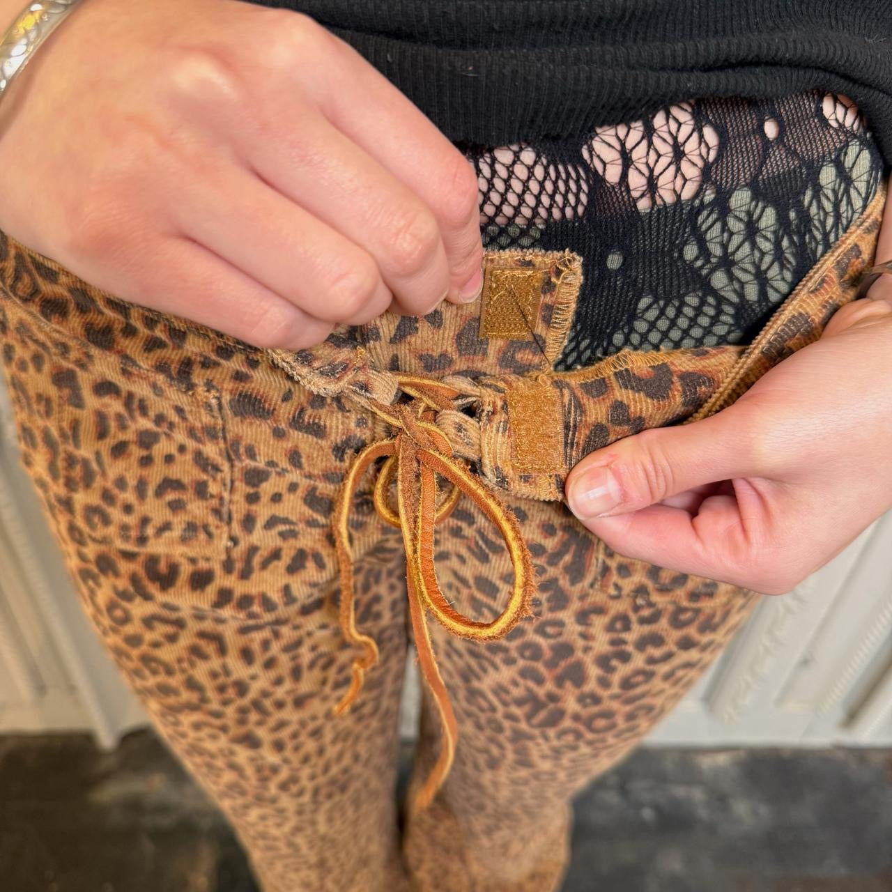 L.E.I. leopard print low rise flare corduroy pants with leather lace up detail